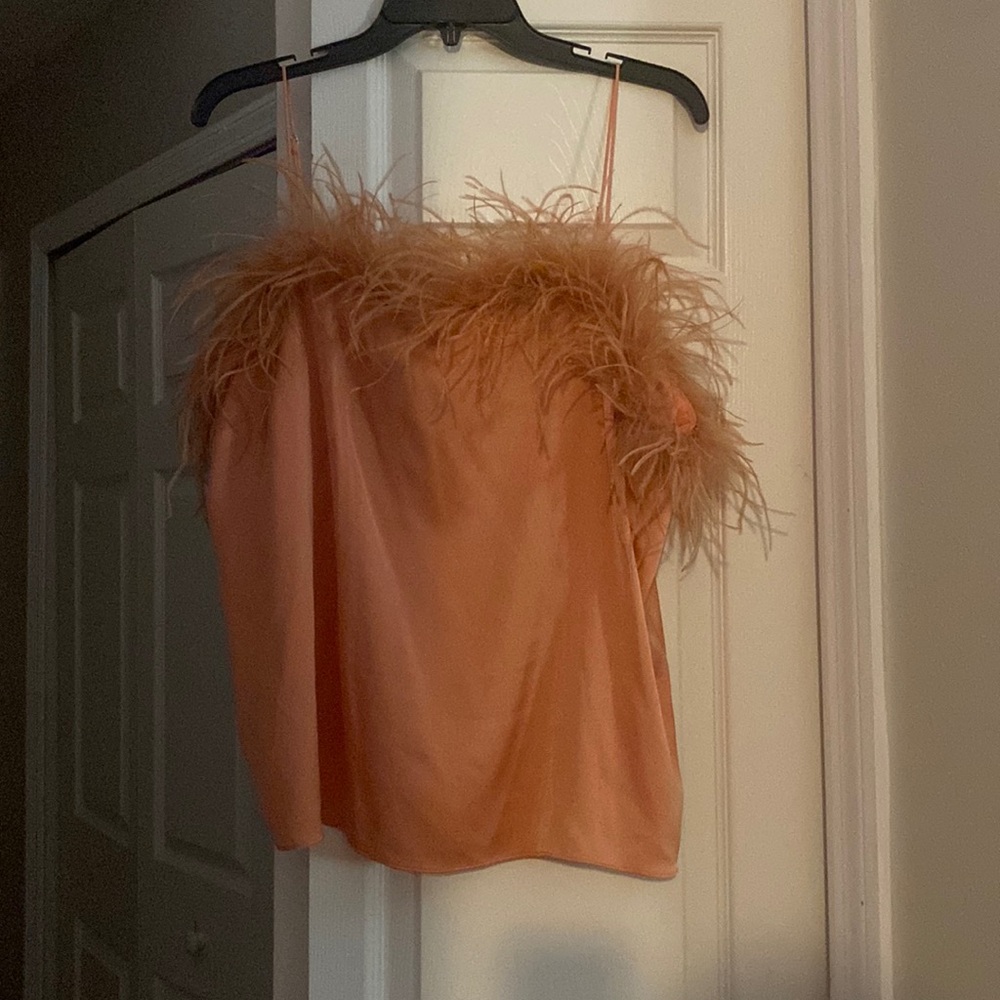 Woman’s top peachy color feathered trim